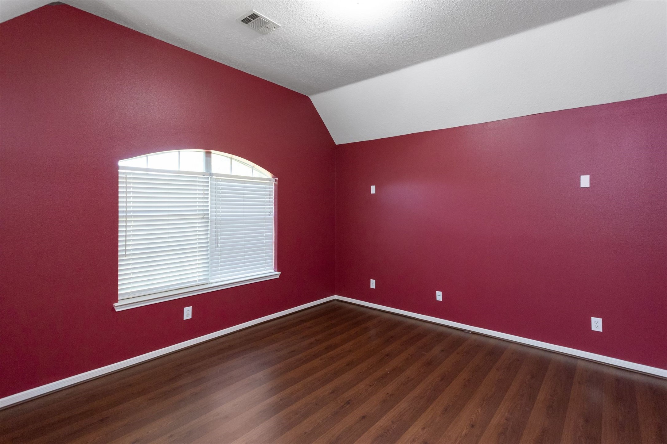 9818 Mossy Tree Lane Houston, TX 77064 - Photo 18 of 28 an empty room with wooden floor and windows