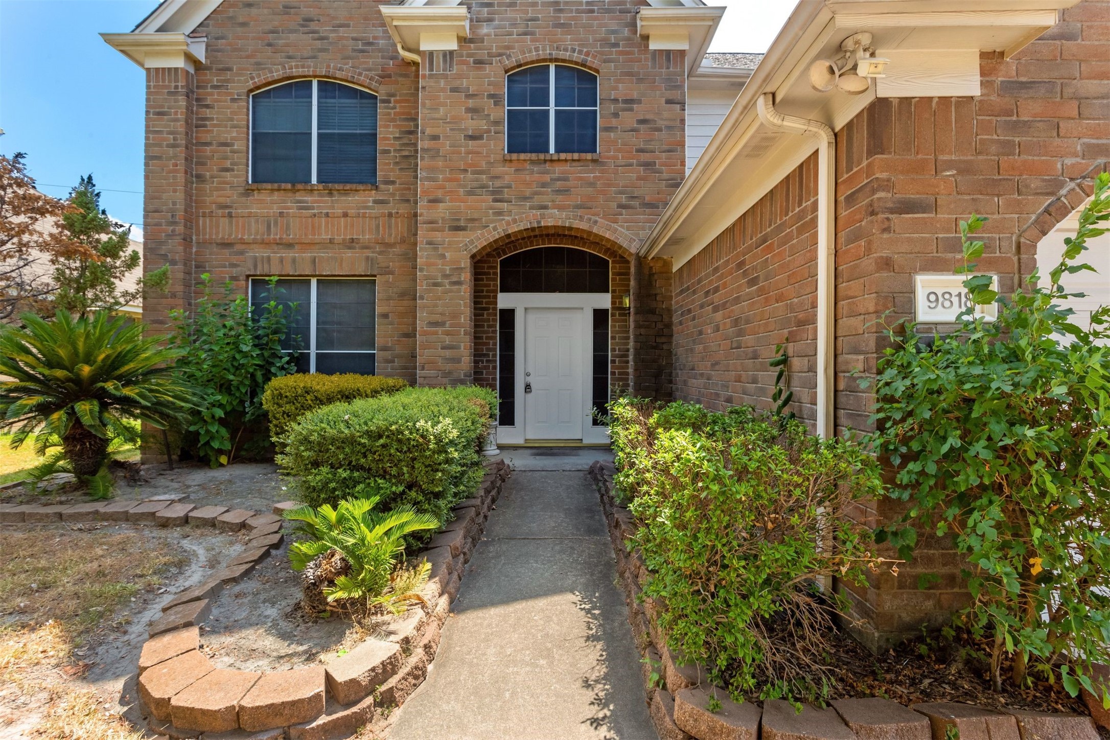 9818 Mossy Tree Lane Houston, TX 77064 - Photo 2 of 28 a front view of a house with garden