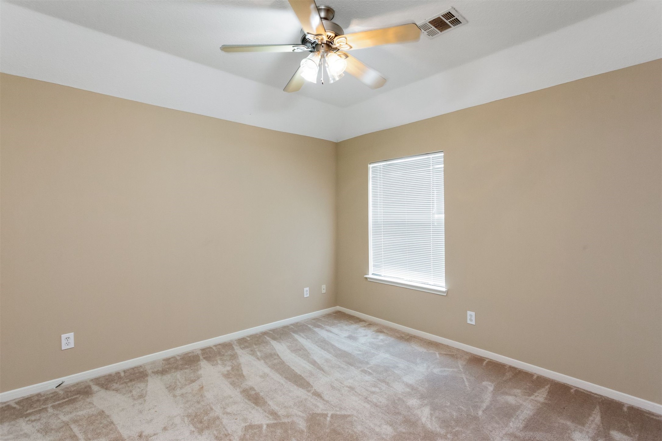 9818 Mossy Tree Lane Houston, TX 77064 - Photo 22 of 28 an empty room with a window and a fan