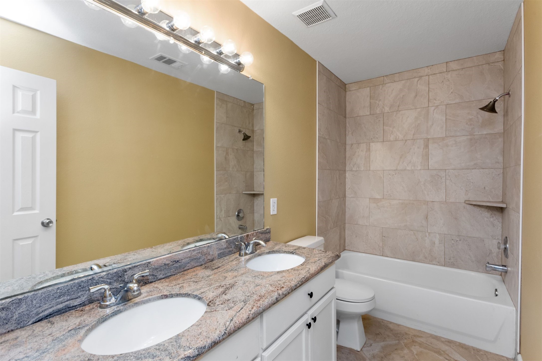 9818 Mossy Tree Lane Houston, TX 77064 - Photo 23 of 28 a bathroom with a granite countertop sink toilet mirror and shower