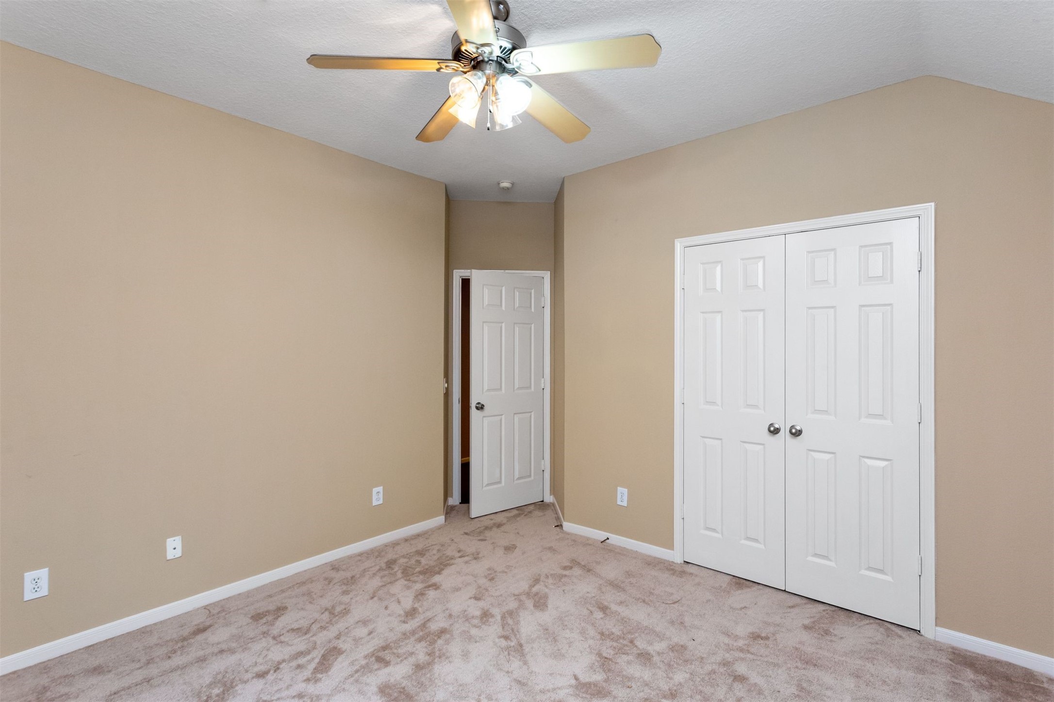9818 Mossy Tree Lane Houston, TX 77064 - Photo 24 of 28 an empty room with a ceiling fan and a window