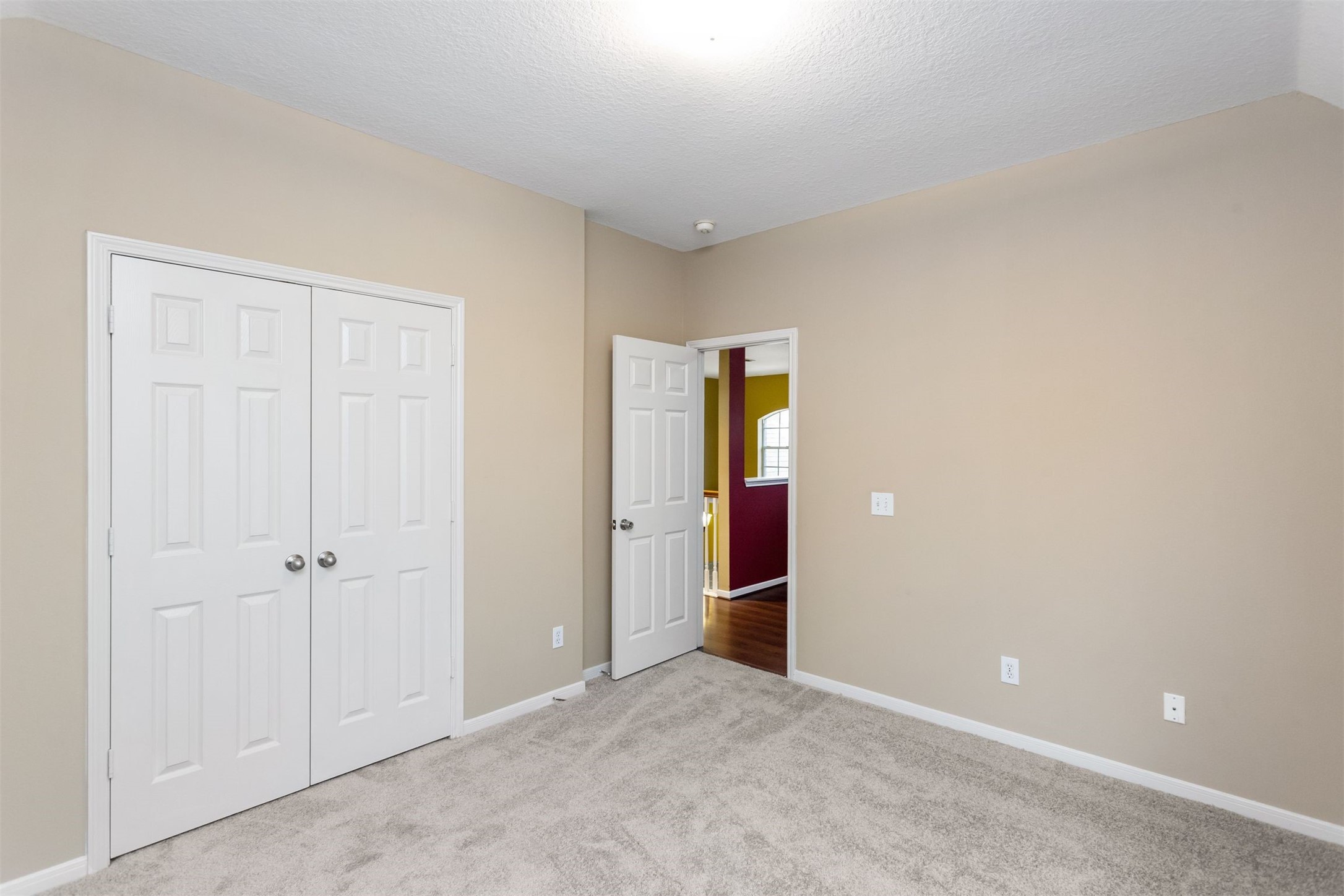 9818 Mossy Tree Lane Houston, TX 77064 - Photo 26 of 28 an empty room with closet and a hallway
