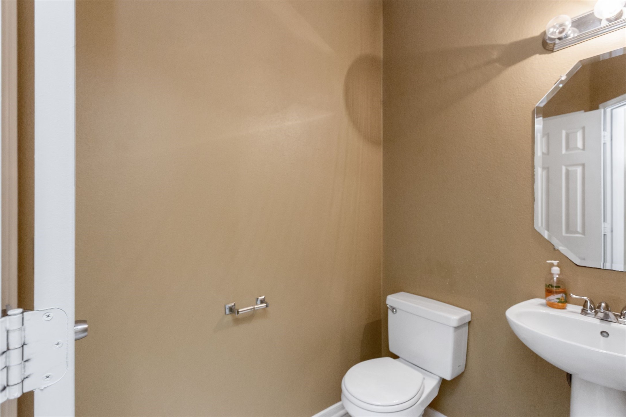 9818 Mossy Tree Lane Houston, TX 77064 - Photo 27 of 28 a white toilet sitting next to a bathroom sink