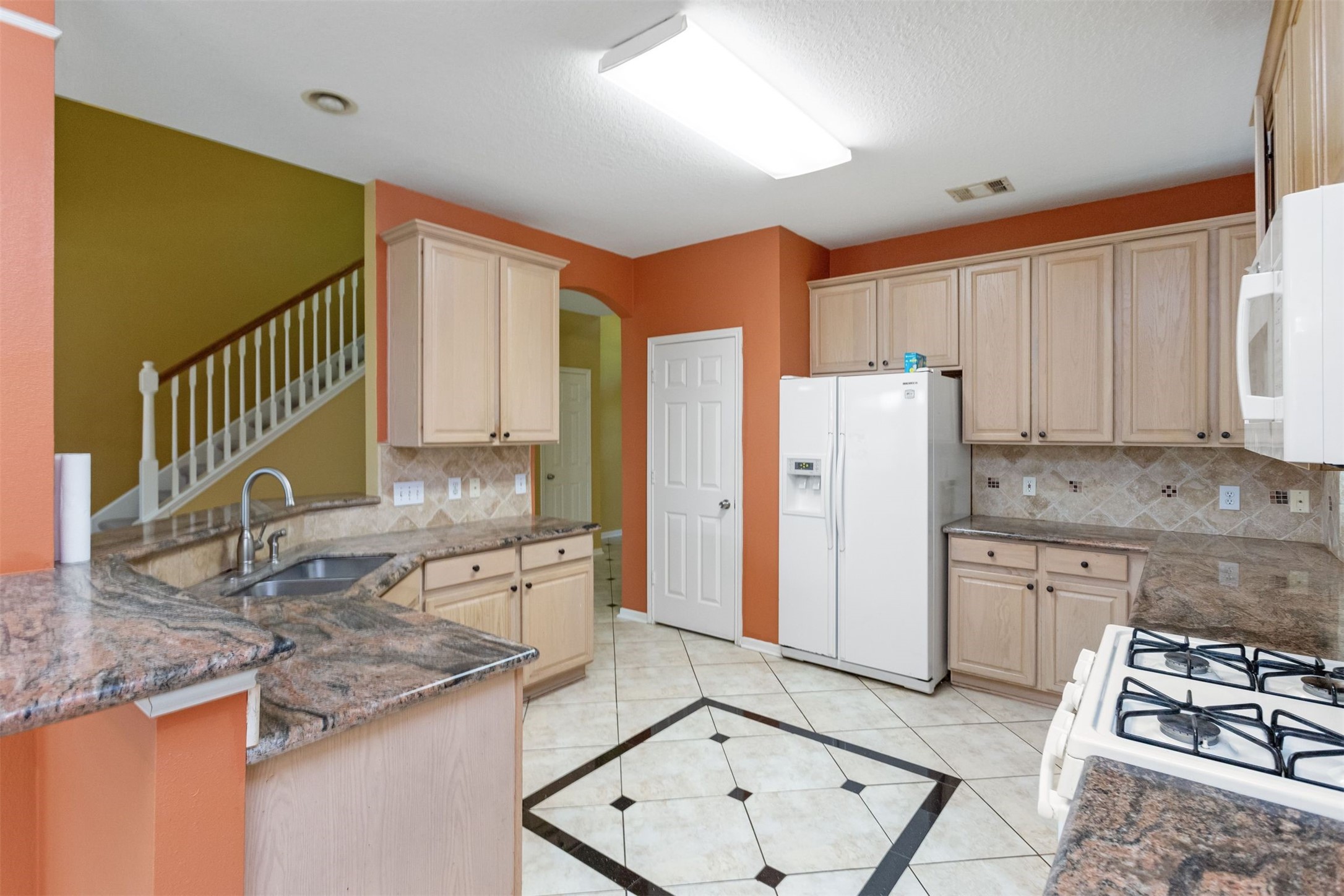 9818 Mossy Tree Lane Houston, TX 77064 - Photo 7 of 28 a kitchen with a sink cabinets and window