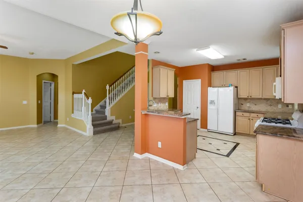 a view of an empty room with a kitchen
