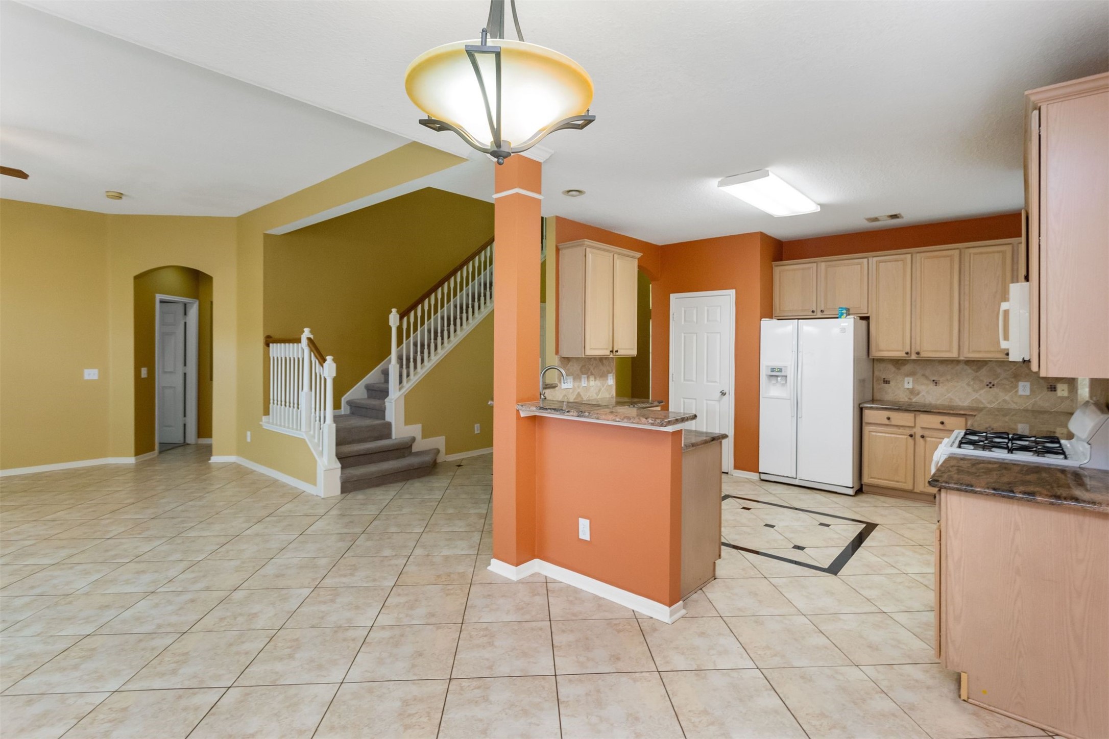 9818 Mossy Tree Lane Houston, TX 77064 - Photo 9 of 28 a view of kitchen with furniture and a ceiling fan