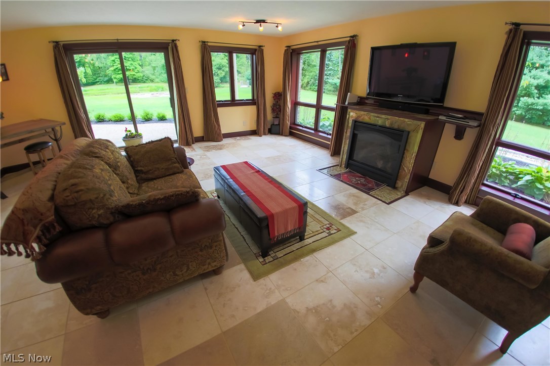 6290 Riverview Road Peninsula, OH 44264 - Photo 26 of 35 Finished walkout basement w/ gas fireplace, Travertine floors & slider to the backyard.