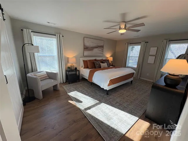 a bedroom with bed couch and window