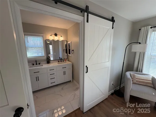 a bathroom with a double vanity sink a mirror and a shower