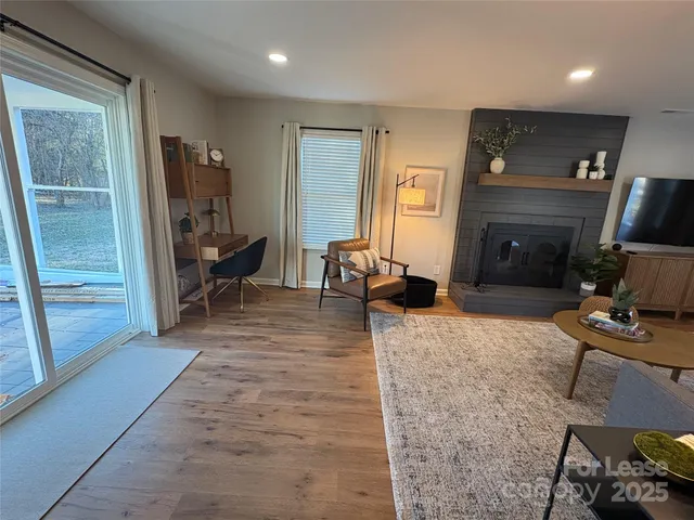 a view of a livingroom with furniture and a flat screen tv