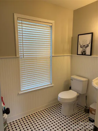 a bathroom with a toilet a sink and a window