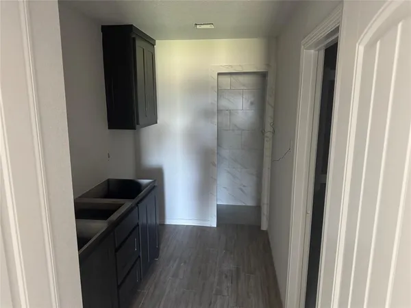 a kitchen with a sink and cabinets