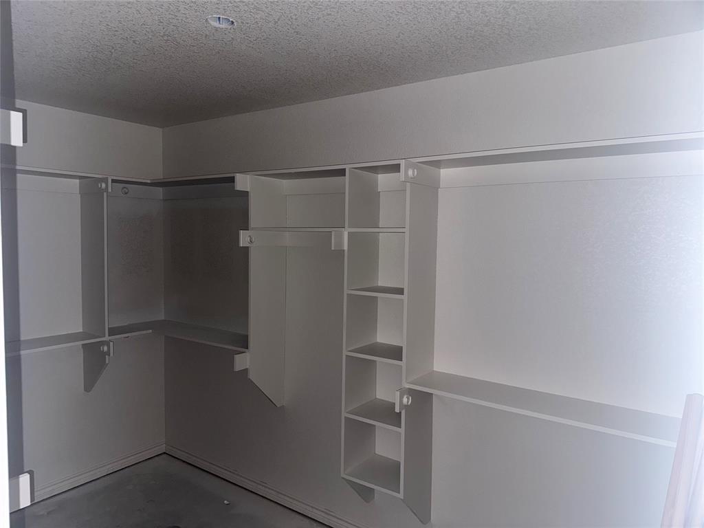 163 Agnes Circle Springtown, TX 76082 - Photo 5 of 7 a view of walk in closet with empty racks