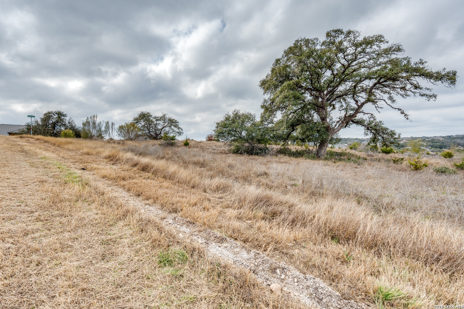 0 Chinook Road New Braunfels, TX 78132 - Photo 8 of 14 a view of a dry yard with wooden fence