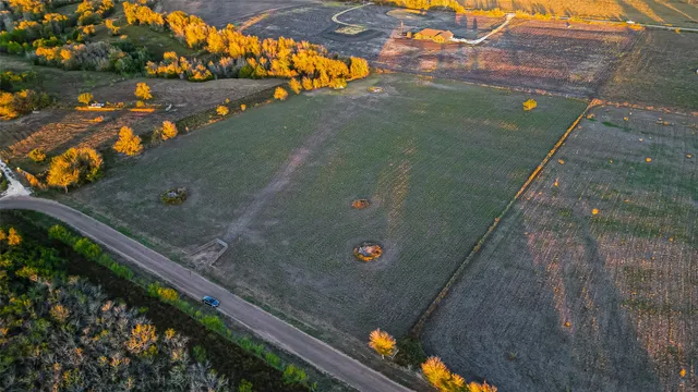 an aerial view of a houses with a yard
