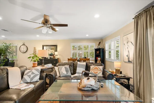 a living room with furniture couches and a large window with garden view