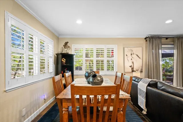 a dining room with furniture window front door and wooden floor