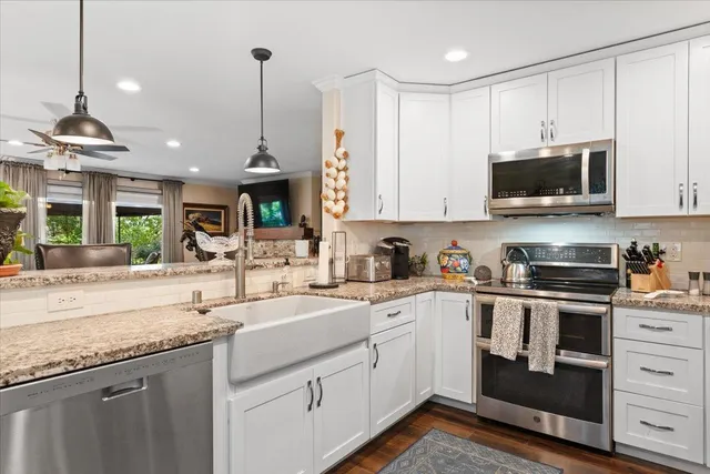 a kitchen with a sink stove and cabinets