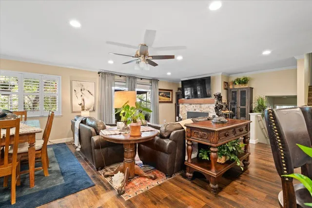 a living room with furniture a fireplace and a flat screen tv