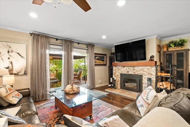 a living room with furniture a flat screen tv and a fireplace