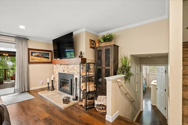a living room with furniture a flat screen tv and a fireplace