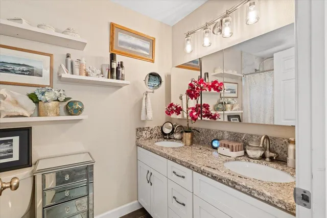 a bathroom with sink mirror and vanity