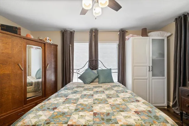 a bedroom with a large bed and a chandelier