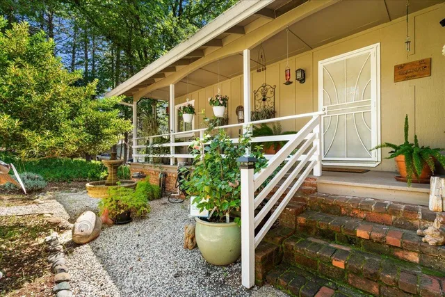 a front view of a house with plants