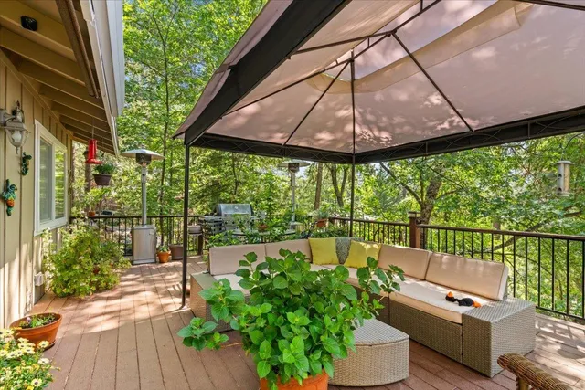 a view of a chairs and table in the balcony