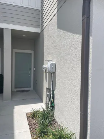 a view of a elevator with potted plant in front of door