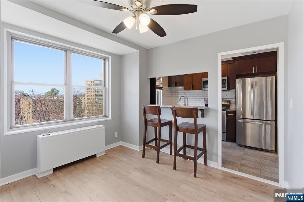 301 Beech Street, Unit 9K Hackensack, NJ 07601 - Photo 12 of 24 a view of a workspace with furniture window and wooden floor