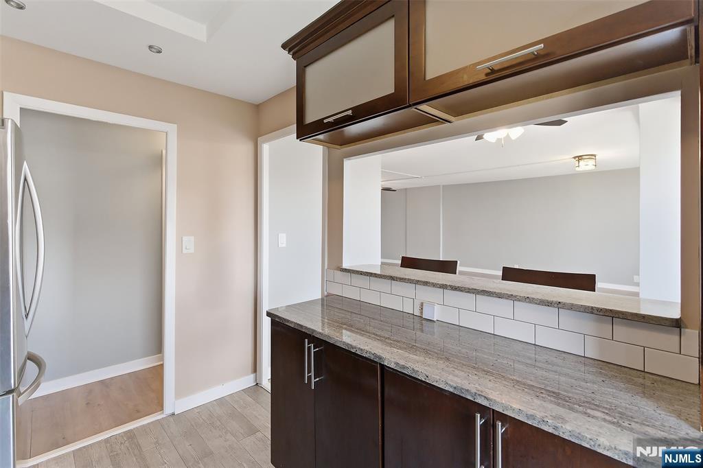 301 Beech Street, Unit 9K Hackensack, NJ 07601 - Photo 14 of 24 a view of a counter top space cabinets and a wooden floor