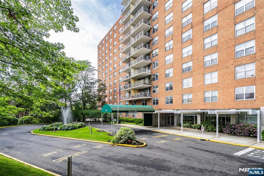 301 Beech Street, Unit 9K Hackensack, NJ 07601 - Photo 2 of 24 a view of tall building with a big yard and plants