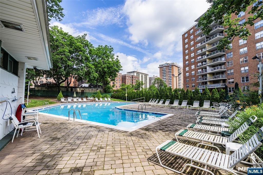 301 Beech Street, Unit 9K Hackensack, NJ 07601 - Photo 4 of 24 a view of a swimming pool with a lounge chair