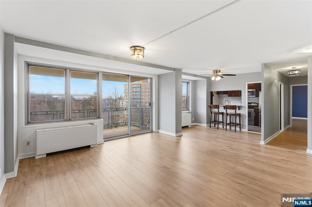 301 Beech Street, Unit 9K Hackensack, NJ 07601 - Photo 7 of 24 a view of an empty room with a window and wooden floor