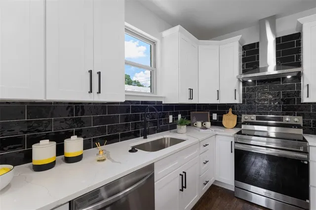 a kitchen with a sink cabinets and wooden floor