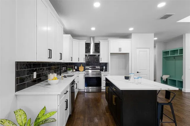a kitchen with a sink stove and cabinets