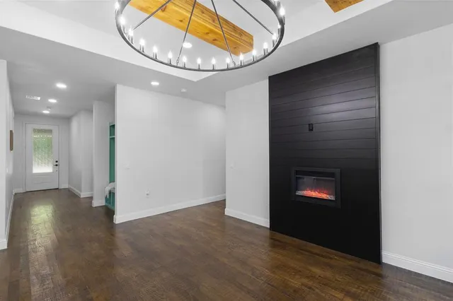 a view of kitchen and dining room with furniture a chandelier and wooden floor