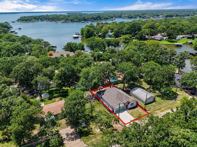 a view of a fireplace with a small yard and a large tree