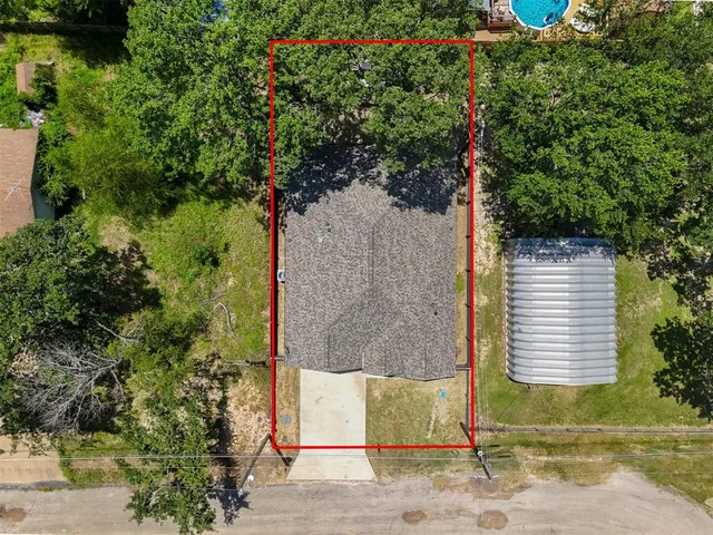 an aerial view of a house with a garden and lake view