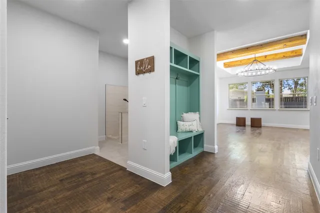 a view of a living room with hardwood floor and a large window