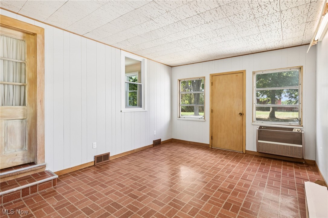 5898 Keller Road Akron, OH 44319 - Photo 25 of 32 Empty room with brick patterned floors and wooden walls