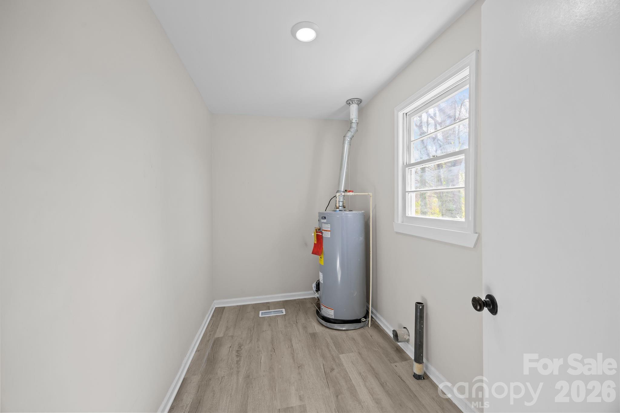 511 East Trade Street Dallas, NC 28034 - Photo 14 of 16 a view of empty room with wooden floor and fan