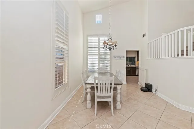 a dining room with furniture and a window