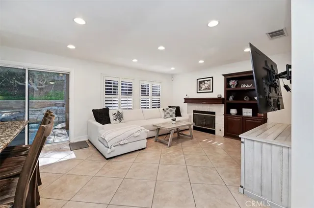 a living room with furniture a rug and a flat screen tv