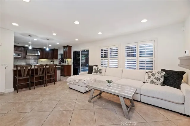 a living room with furniture and kitchen view