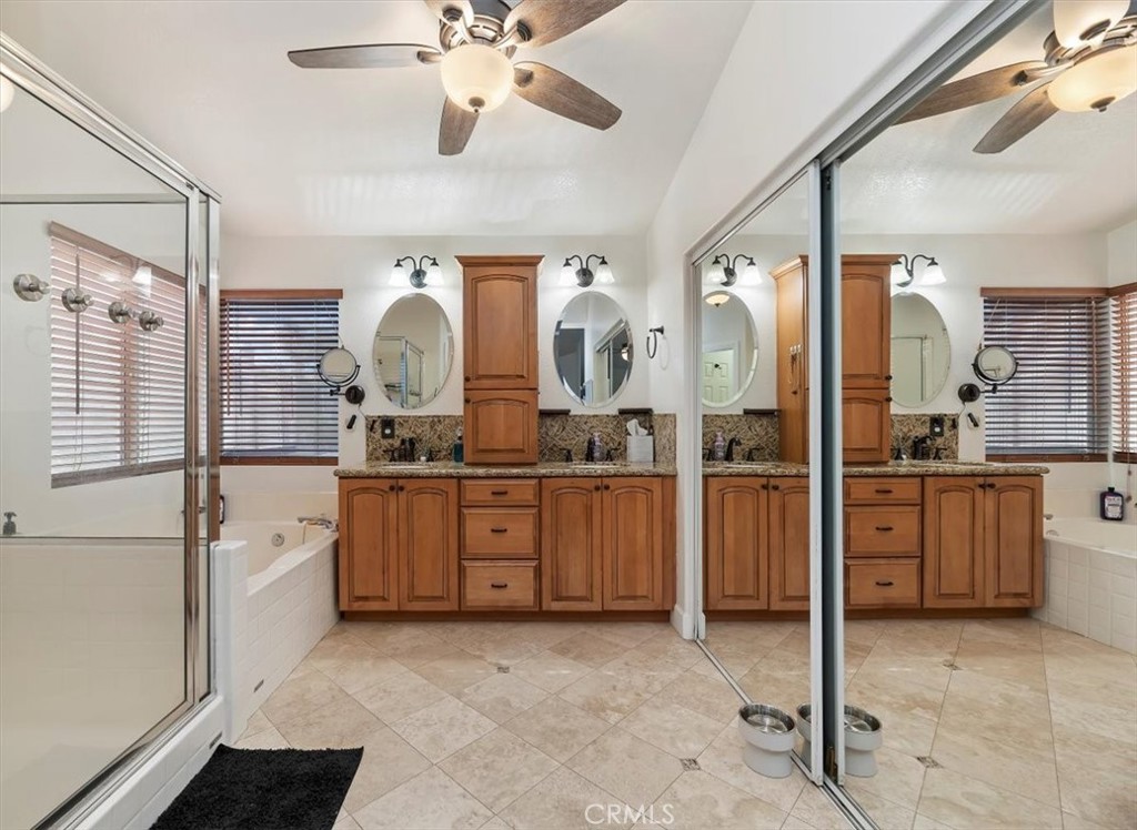 1040 Nighthawk Circle Corona, CA 92881 - Photo 30 of 39 a spacious bathroom with a granite countertop sink mirror and shower