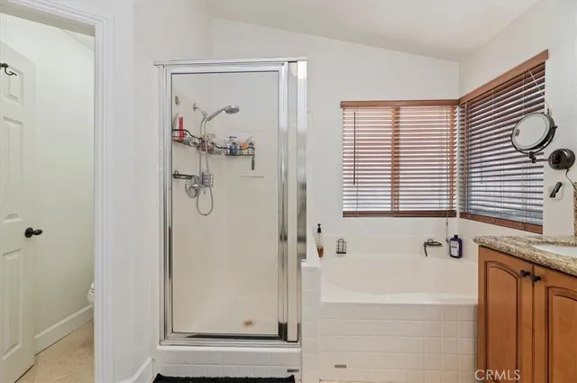 a bedroom with a bed and a desk