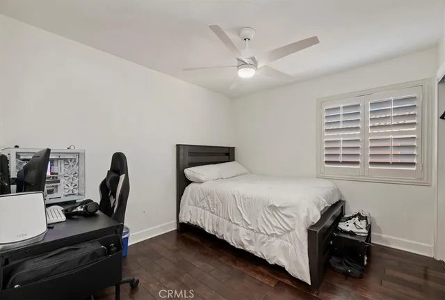a bedroom with 2 bed and a chandelier