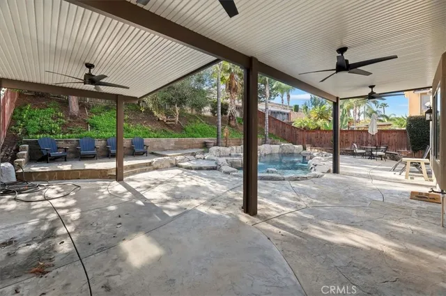 a view of a patio with swimming pool table and chairs